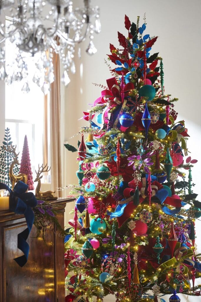 Bold, bright, and full of fun—this RAZ tree bursts with jewel tones, glittered sprays, velvet ribbons, and oversized ornaments.