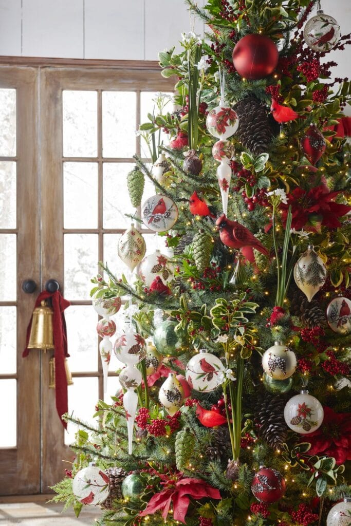 RAZ “Holly & Pine” Christmas Tree This tree brings the outdoors in with natural charm—pinecones, sprigs of holly, and vivid red cardinals nestled among lush greenery.