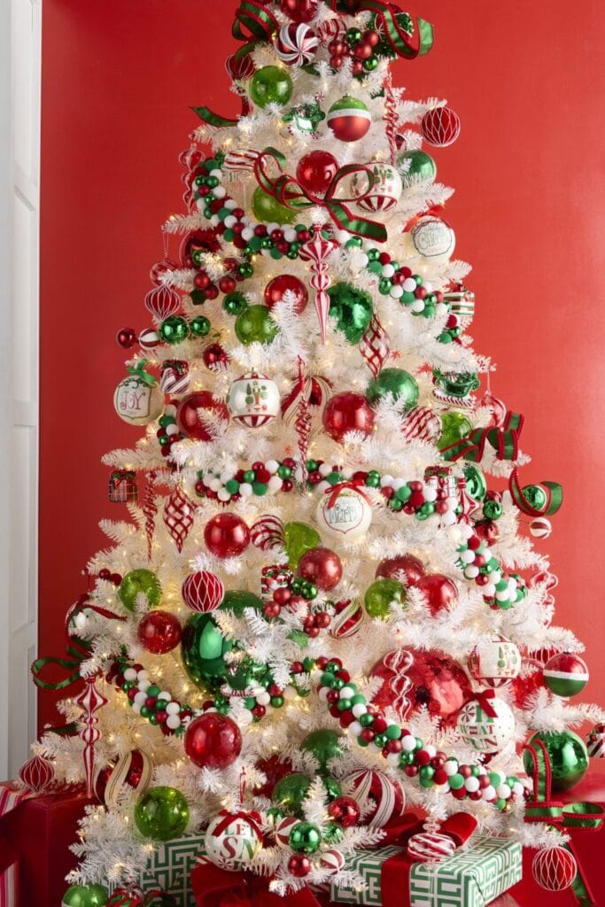 RAZ Make it Merry Christmas tree - This whimsical white tree bursts with red, green, and candy-striped ornaments, playful garlands, oversized baubles, and festive bows