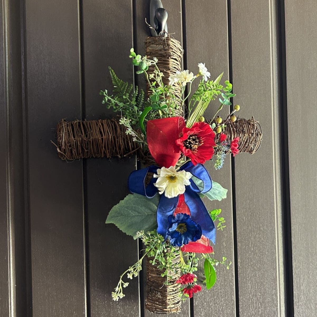patriotic twig cross with floral spray and ribbon