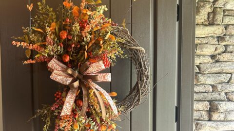 fall florals on a grapevine wreath with simple bow