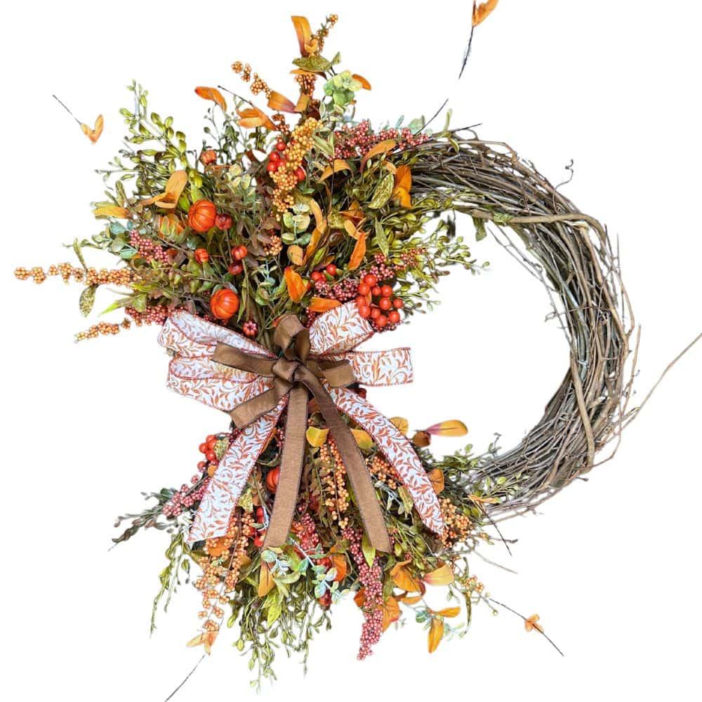 grapevine twig wreath with fall florals and a bow