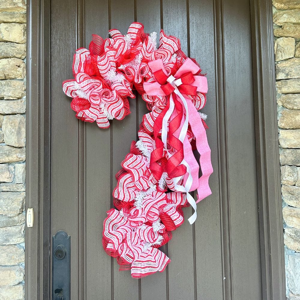 new pink, red and white snow fuzz mesh made with red breeze mesh on a 30" candy cane form, red, white and pink bow made with Em's Bowmaker