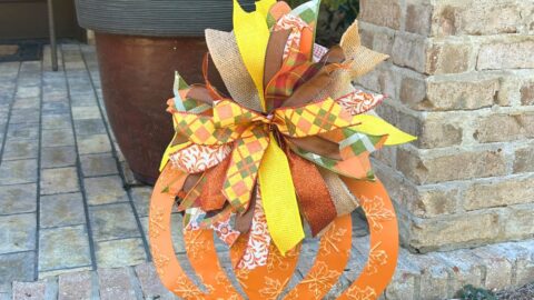 ribbon strip bow on a fall pumpkin yard welcome sign