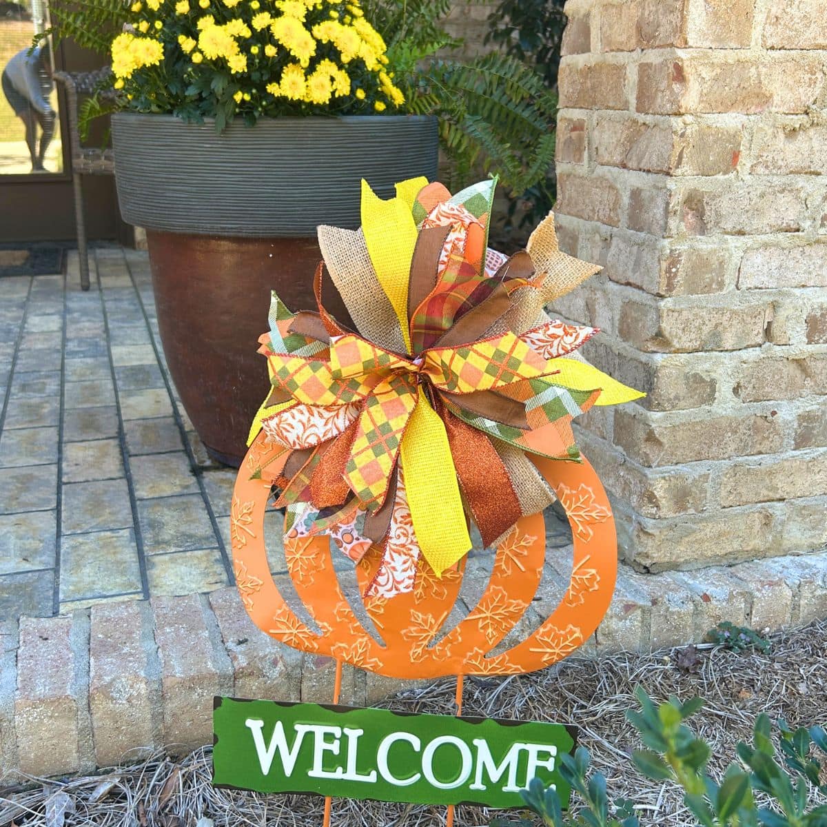 ribbon strip bow on a fall pumpkin yard welcome sign
