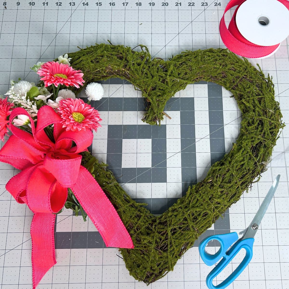 moss heart with simple gerber daisies and pink bow