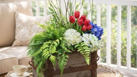 Decorating with faux florals in an old wooden crate showing how a few florals can make a big impact