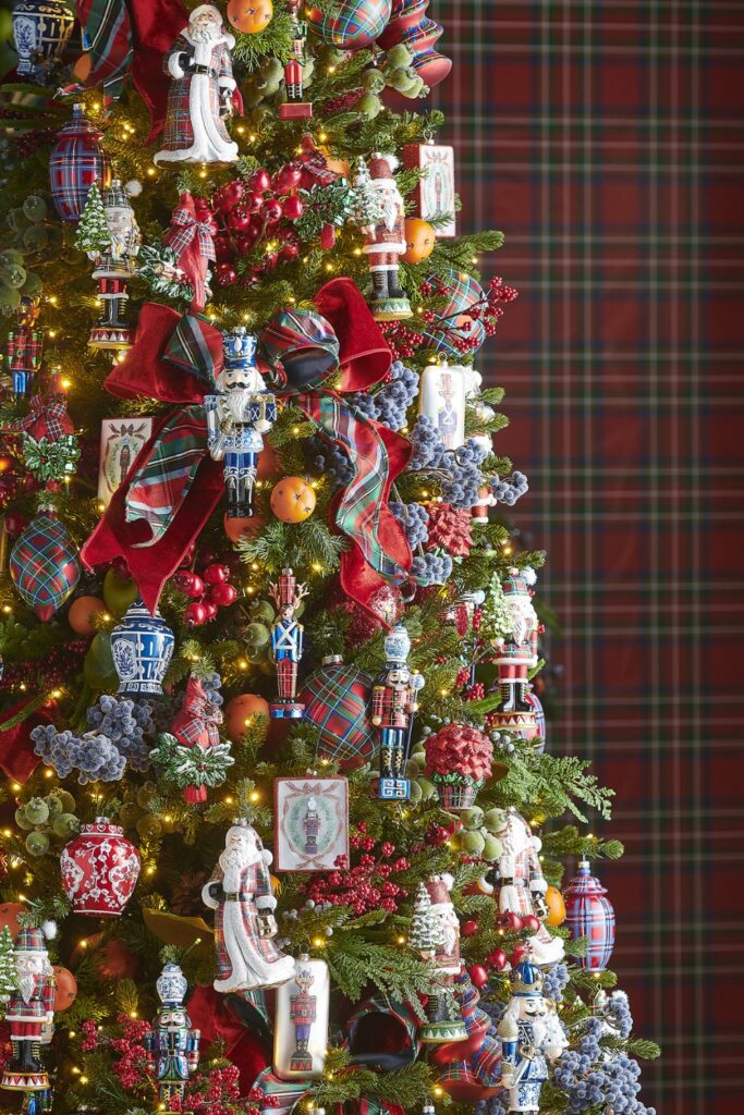 Christmas tree decorated with traditional red and green plaid ribbon, nutcracker ornaments, chinoiserie accents, and classic holiday ornaments in the Home for the Holidays theme.