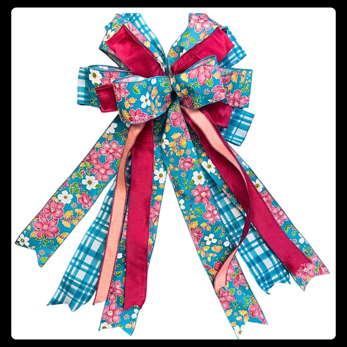 Wreath bow made with multiple sizes and styles of ribbon using the Em's Bow & Go foldable bowmaker from Trendy Tree.